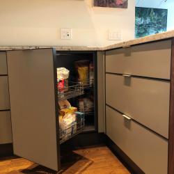 Aluminum kitchen cabinets in two-tone brown and beige and including smart corner pull-out