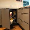 Aluminum kitchen cabinets in two-tone brown and beige and including smart corner pull-out