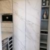 Aluminum pantry cabinets in grey and including doors in Neolith