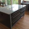 medium grey kitchen cabinets with silver frames natural stone countertops