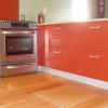 brick red, glass uppers, recycled glass countertop olive colour, red backsplash